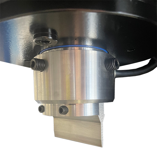 Piston end cap with integrated tool slot on hydraulic press for custom tools.